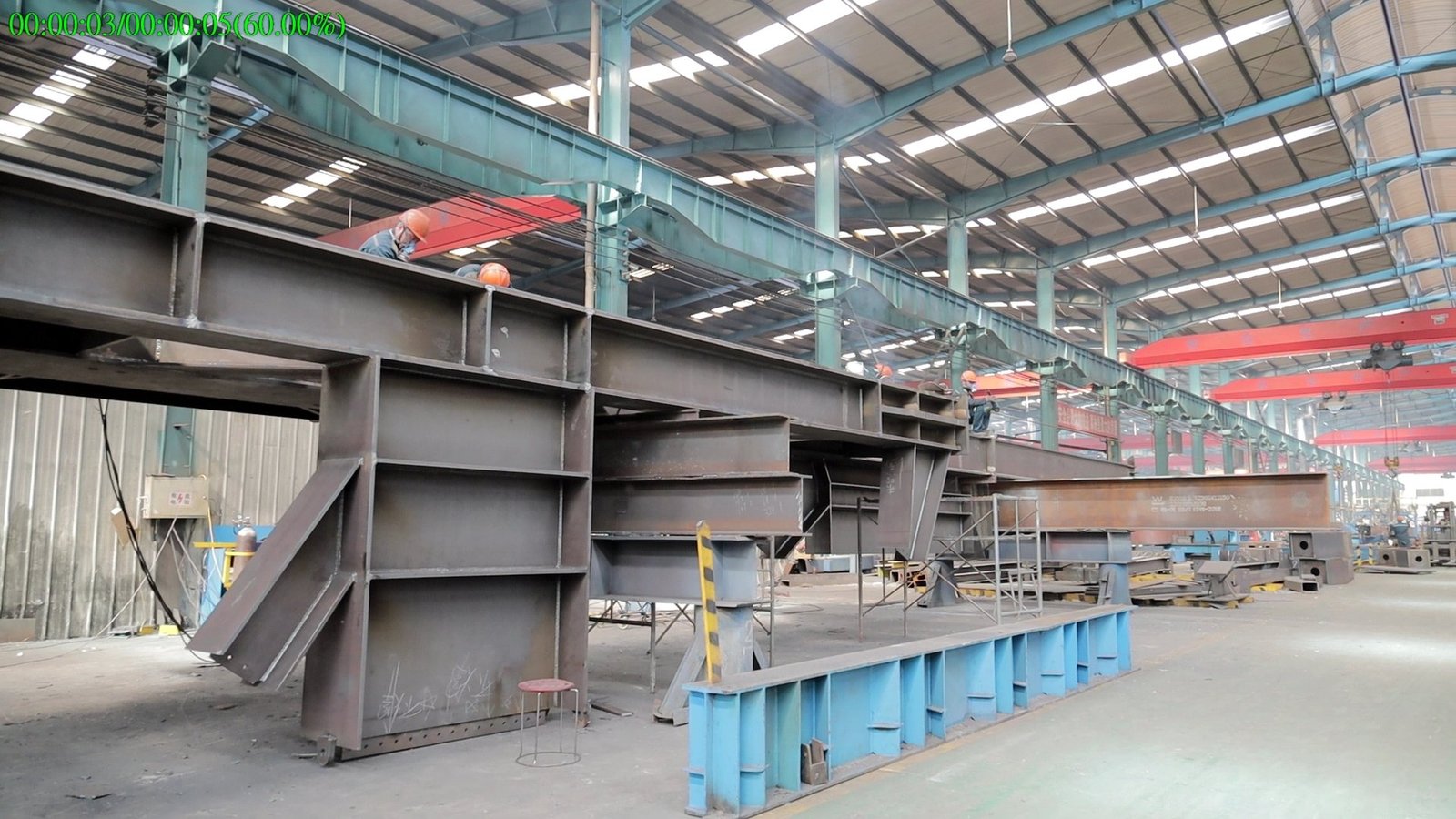 Steel fabrication facility with overhead cranes